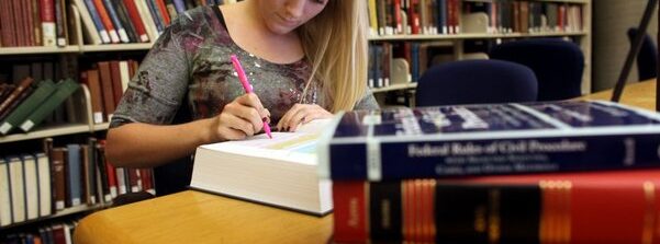 woman writing on desk